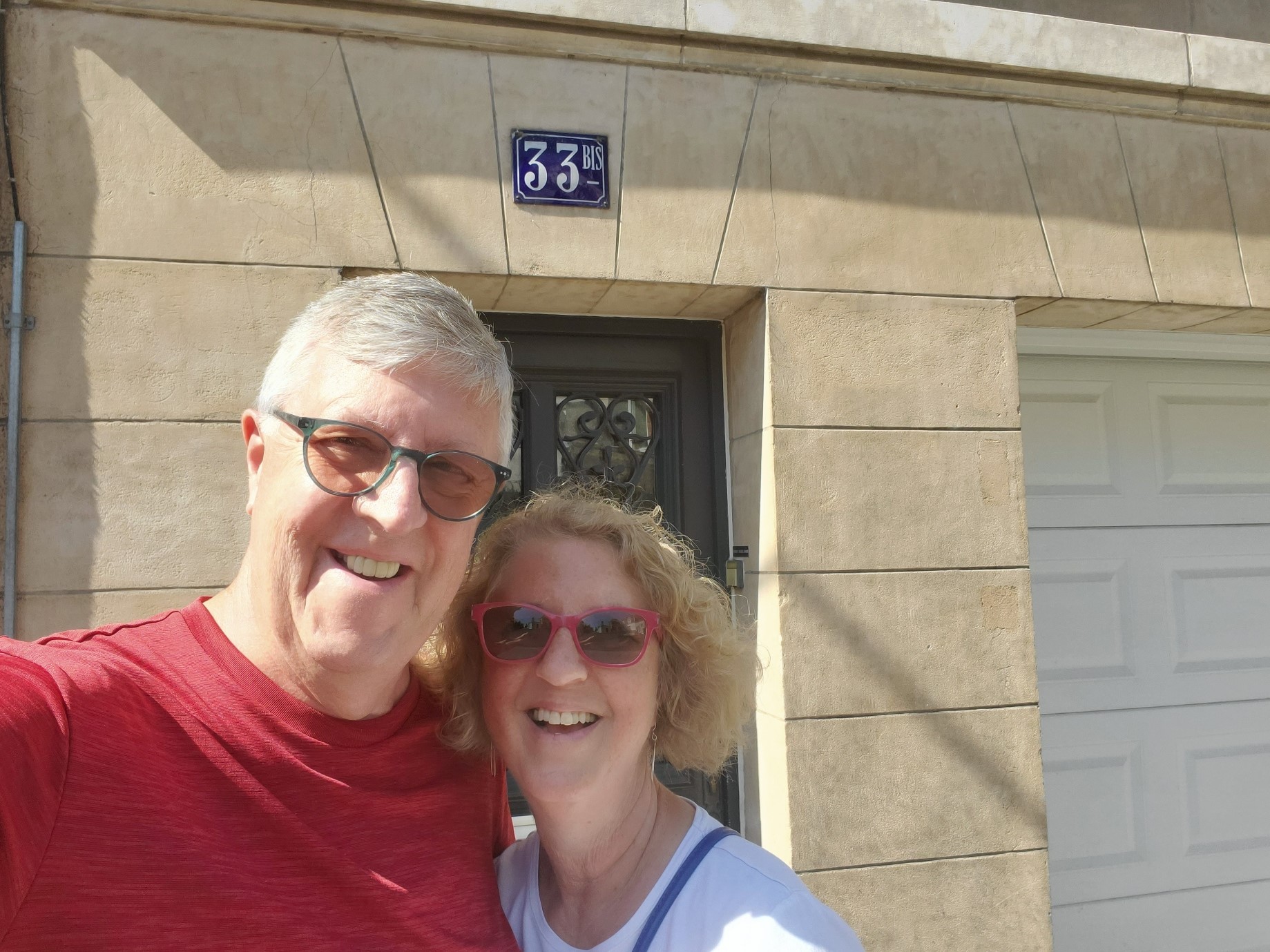 A photo of a couple in front of a building