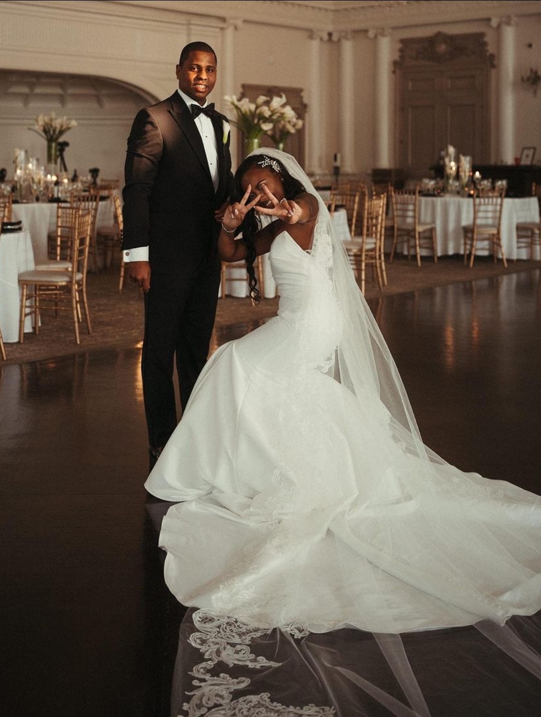 A bride and groom pose for a wedding photo