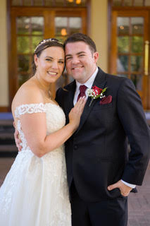 A recently married couple posing for a wedding photo