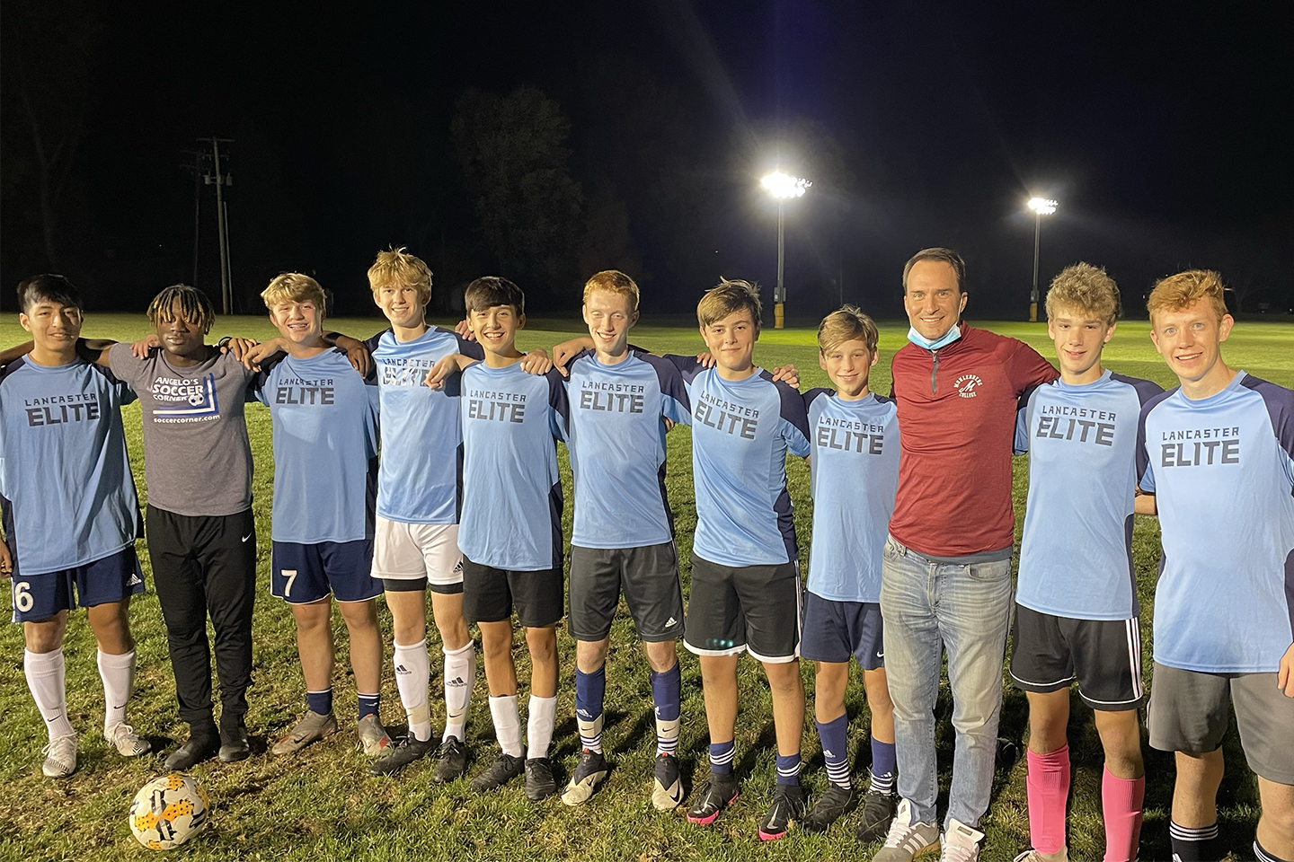 Dave Vassilaros ’03 (in red) with a soccer team he was coaching in November 2020