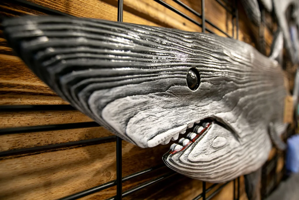 A close up of a wooden carved shark