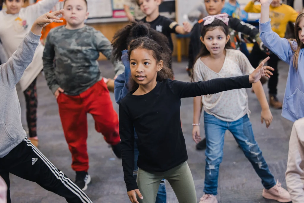 Second graders participate in dance class in their classroom