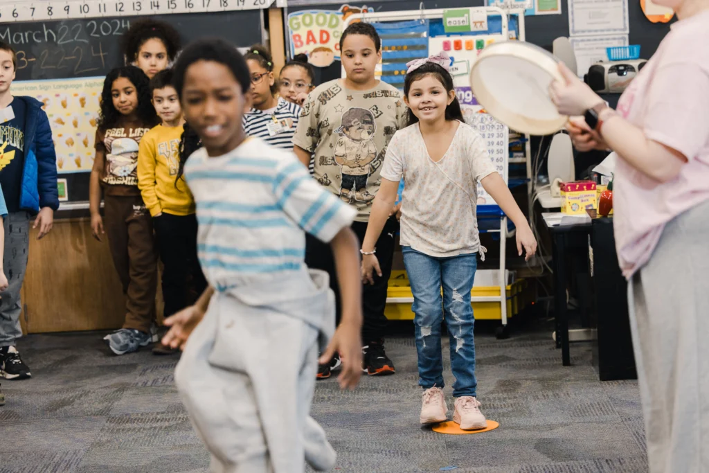 Second graders march to the beat of a small drum