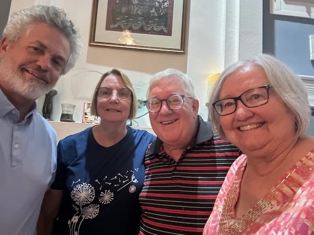 Four older people smiling for the camera