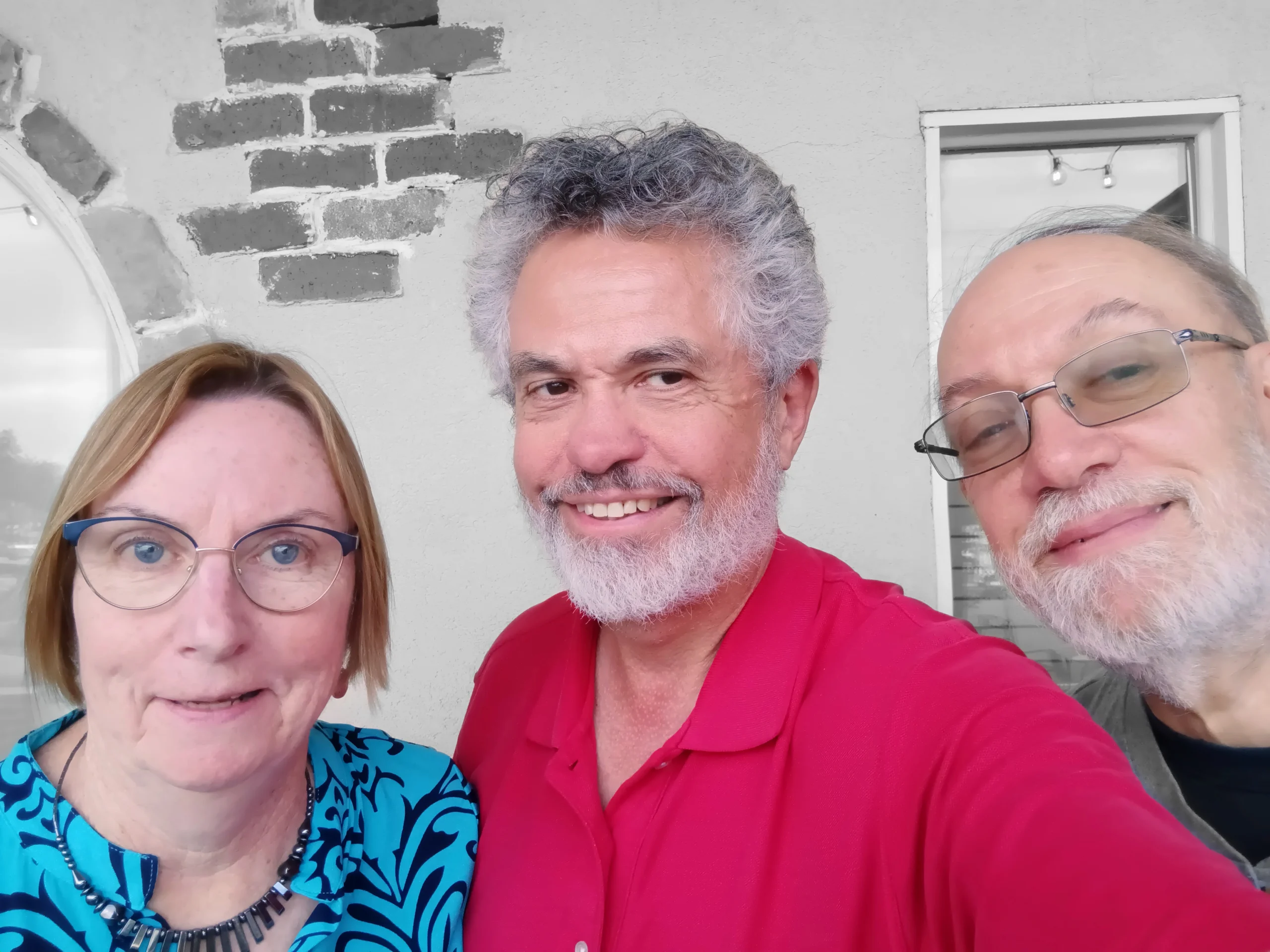 Three older people smiling at the camera