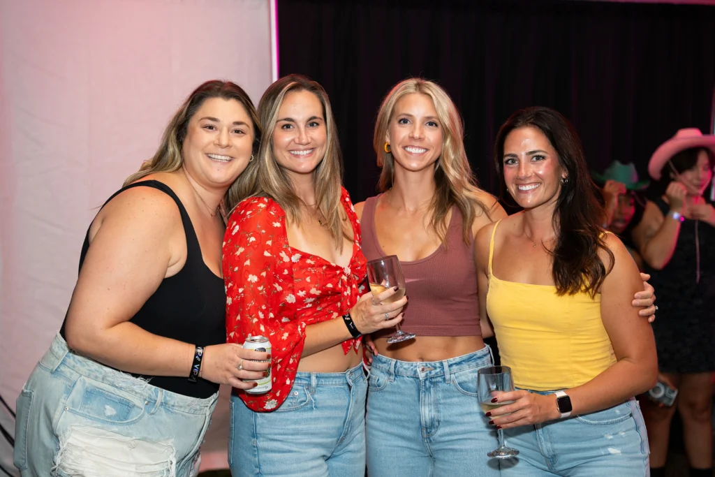 Four women smile for a photo