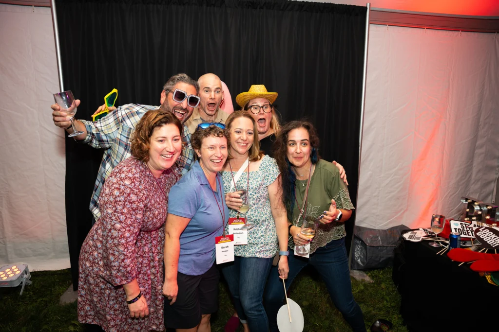 A group of adults pose in a photobooth