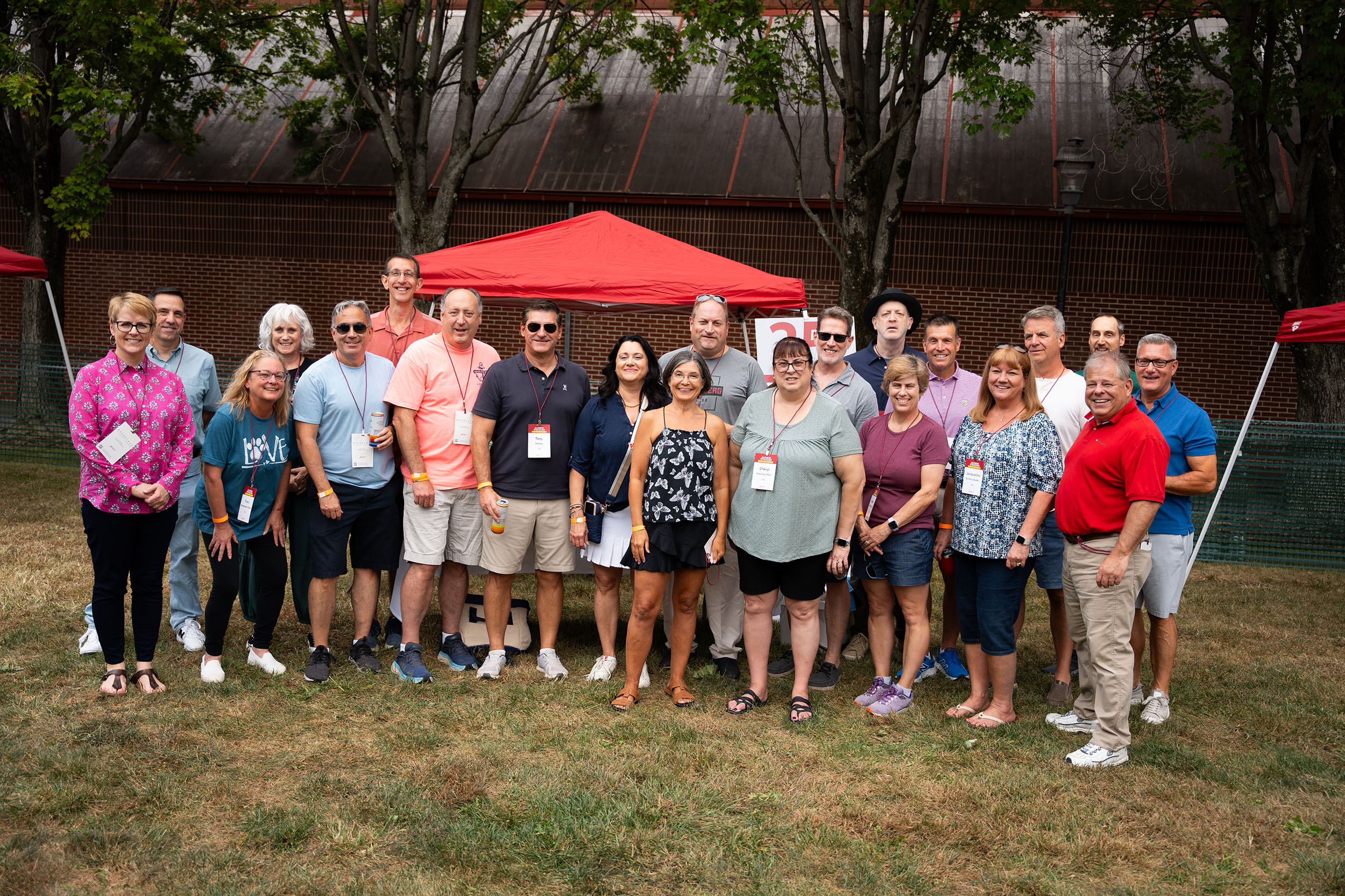 A large group of people in front of a tent that says 35th reunion