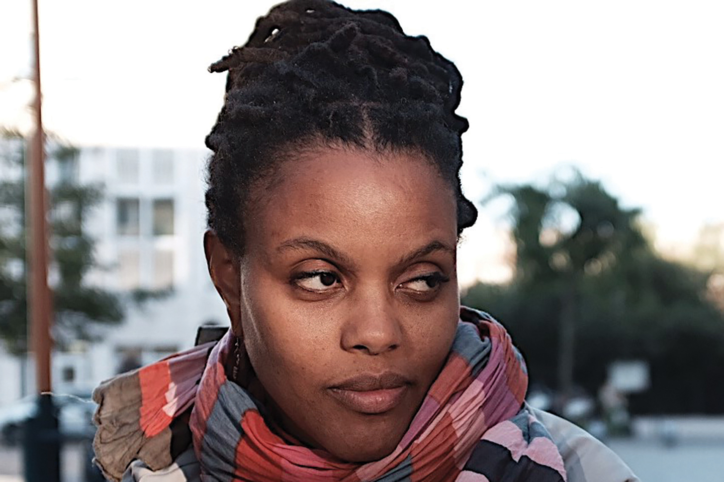 A headshot of a college professor wearing a colorful scarf