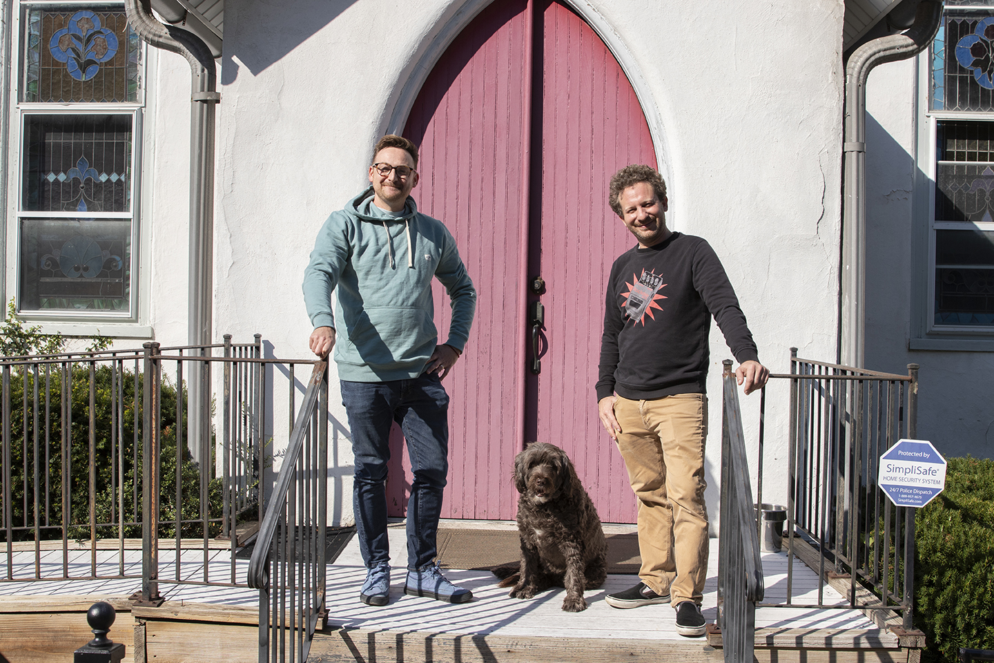 Two adults in front of the door of a church