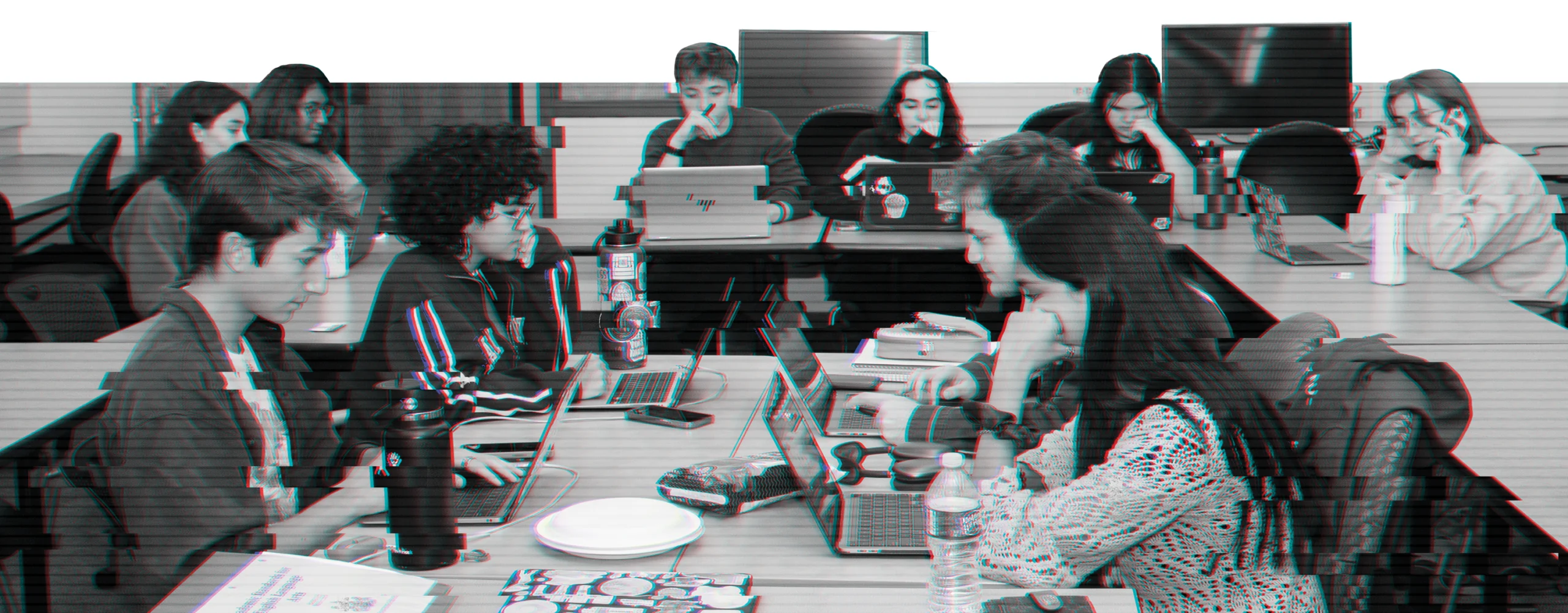 Photo of a group of students working on their laptops together.