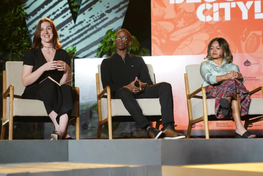 Maddie Davidson seated on a stage and speaking during a panel 