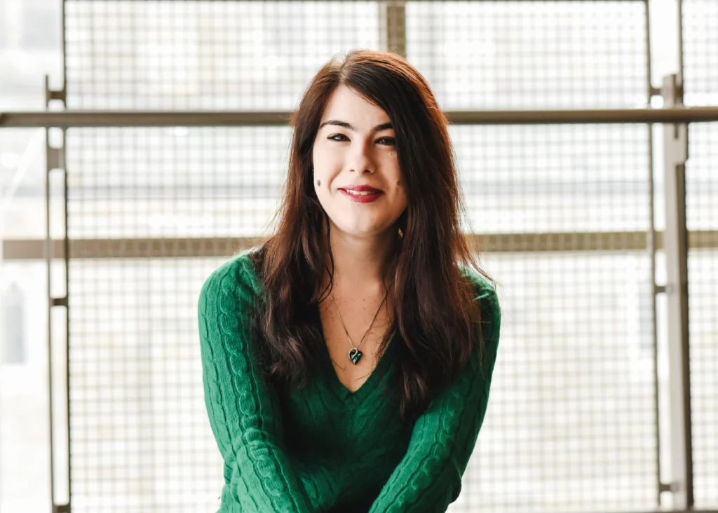 Emma Shay smiling while seated