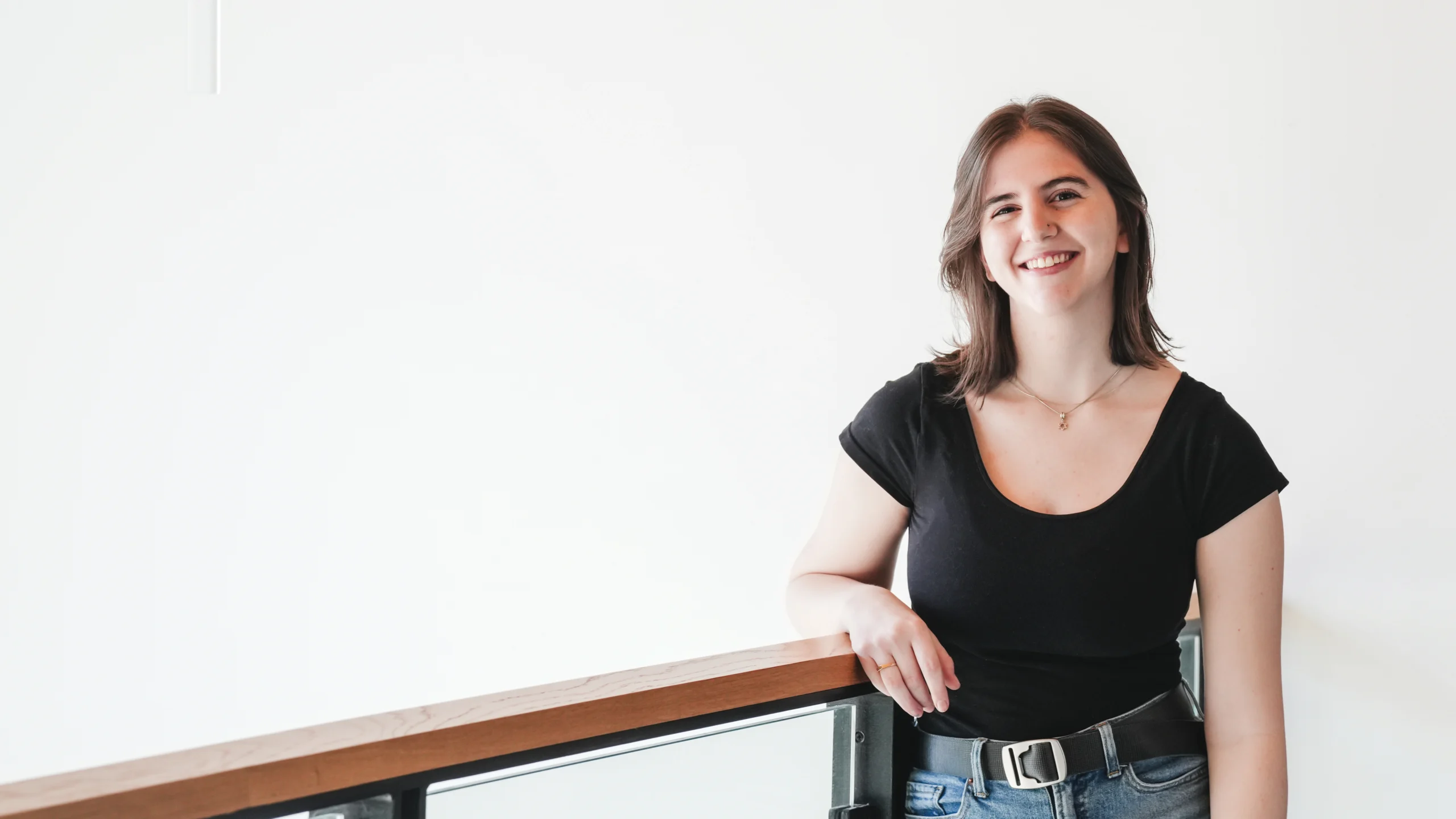 Maddie Davidson smiling at the camera with a blank background