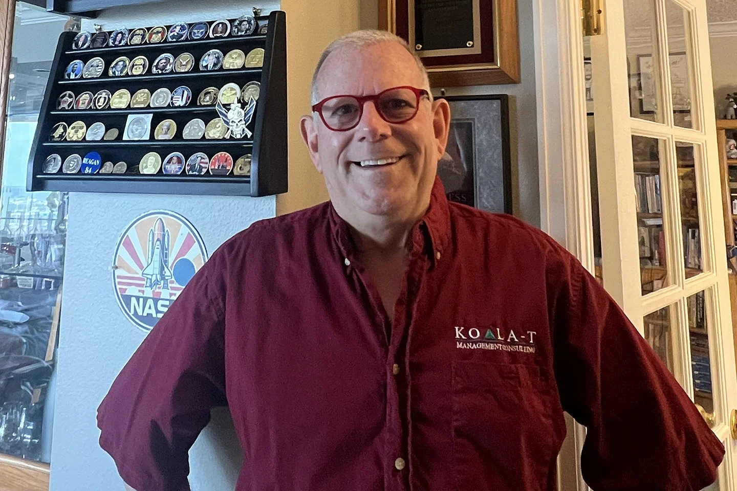 A man in a red shirt and glasses